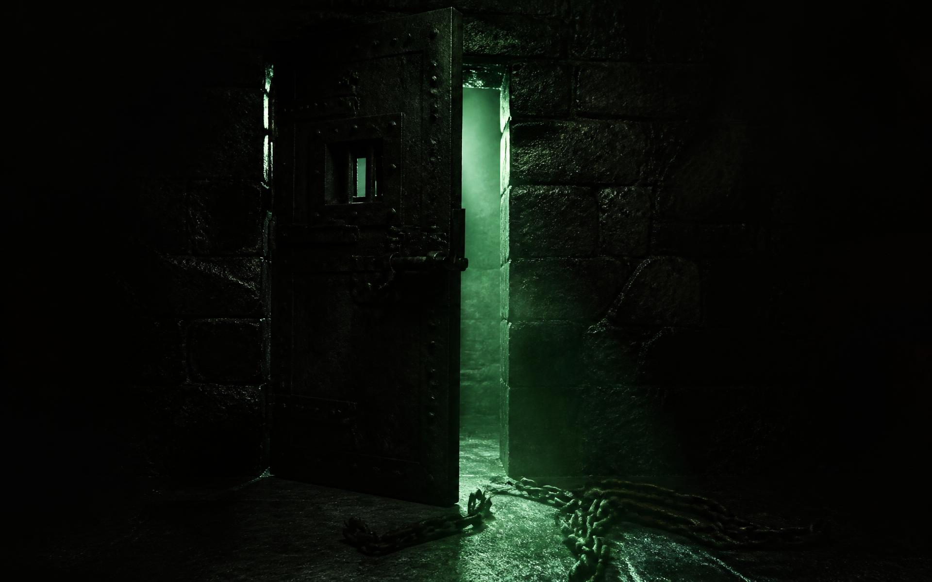 An iron prison door standing ajar with broken chains and light beyond